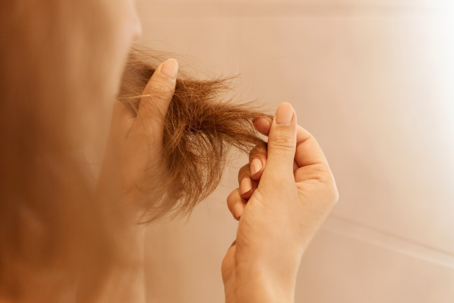 A woman stroking the ends of her hair