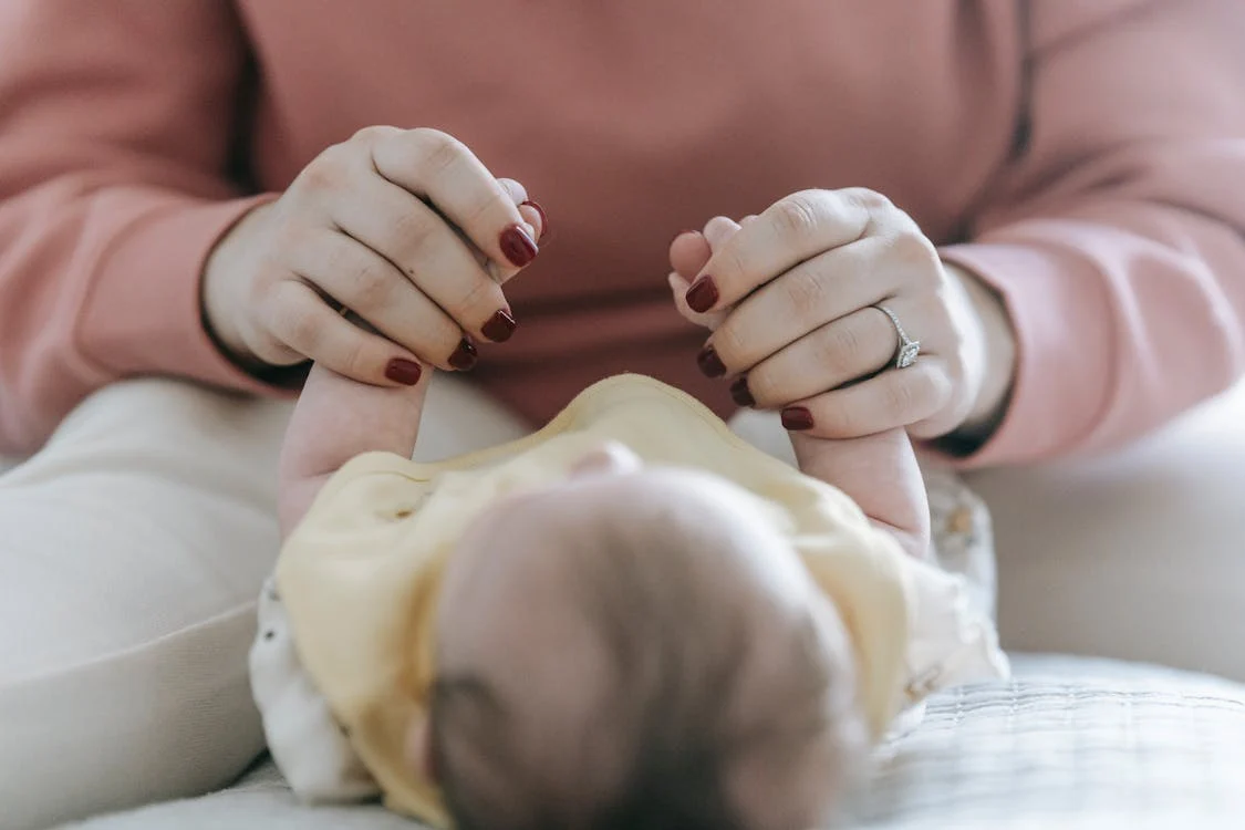 mom changing cloth diapers for kid