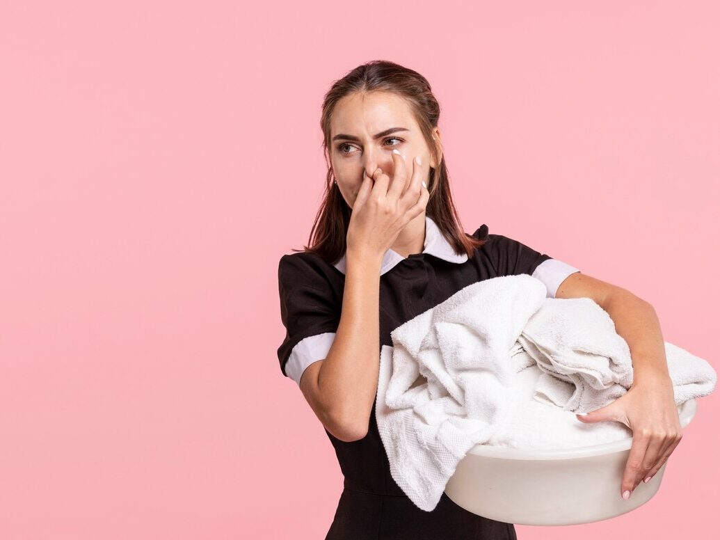 medium shot maid holding smelly laundry basket 23 2148246587 edited