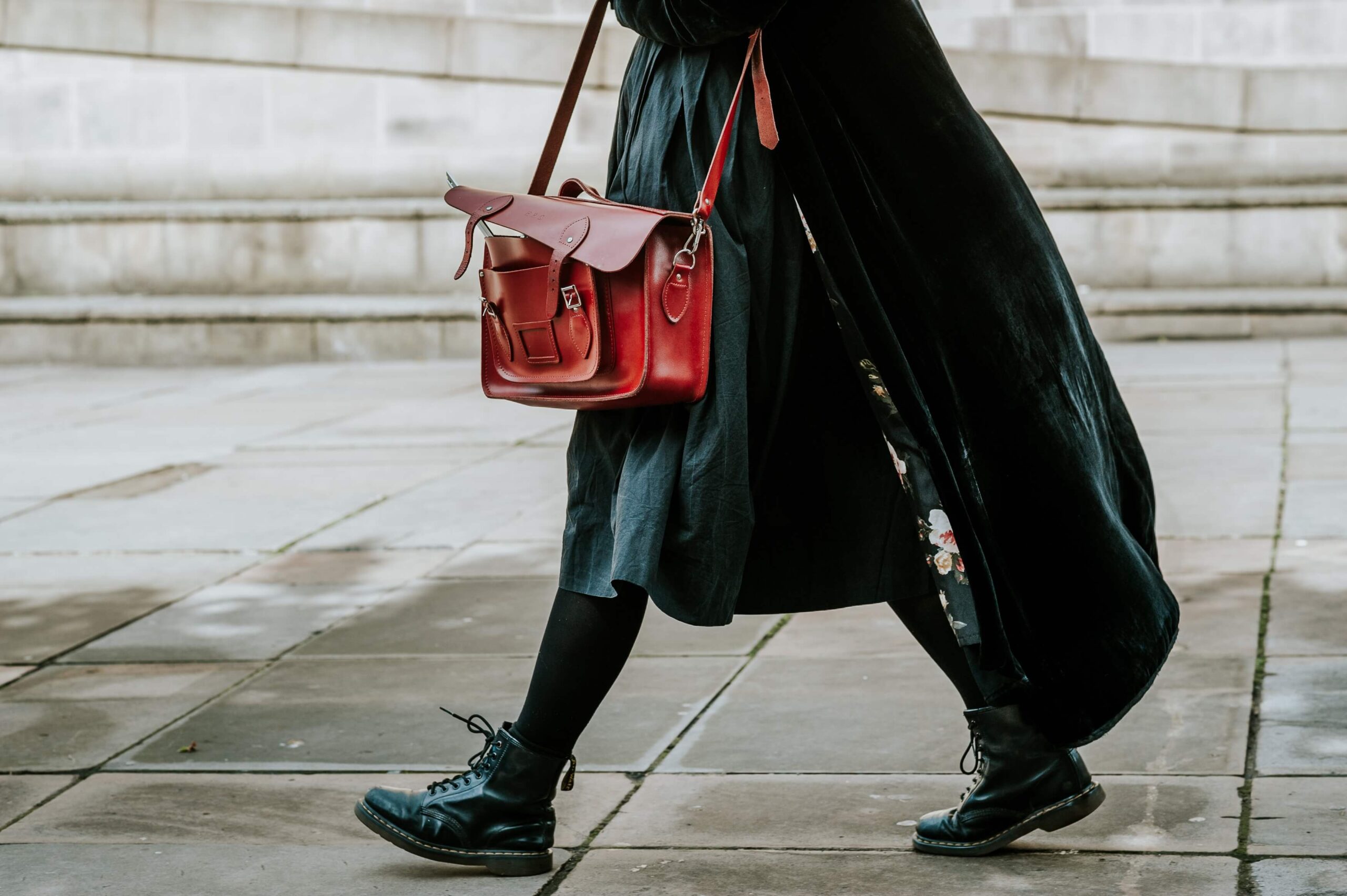 person black coat carrying satchel bag while walking street 1 scaled